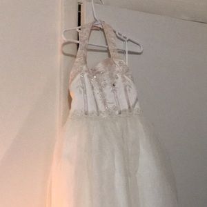 A white and light pink children’s wedding dress.